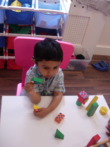 Child playing with blocks in the Busy Bees room at Early Learners' Nursery School, Leicester